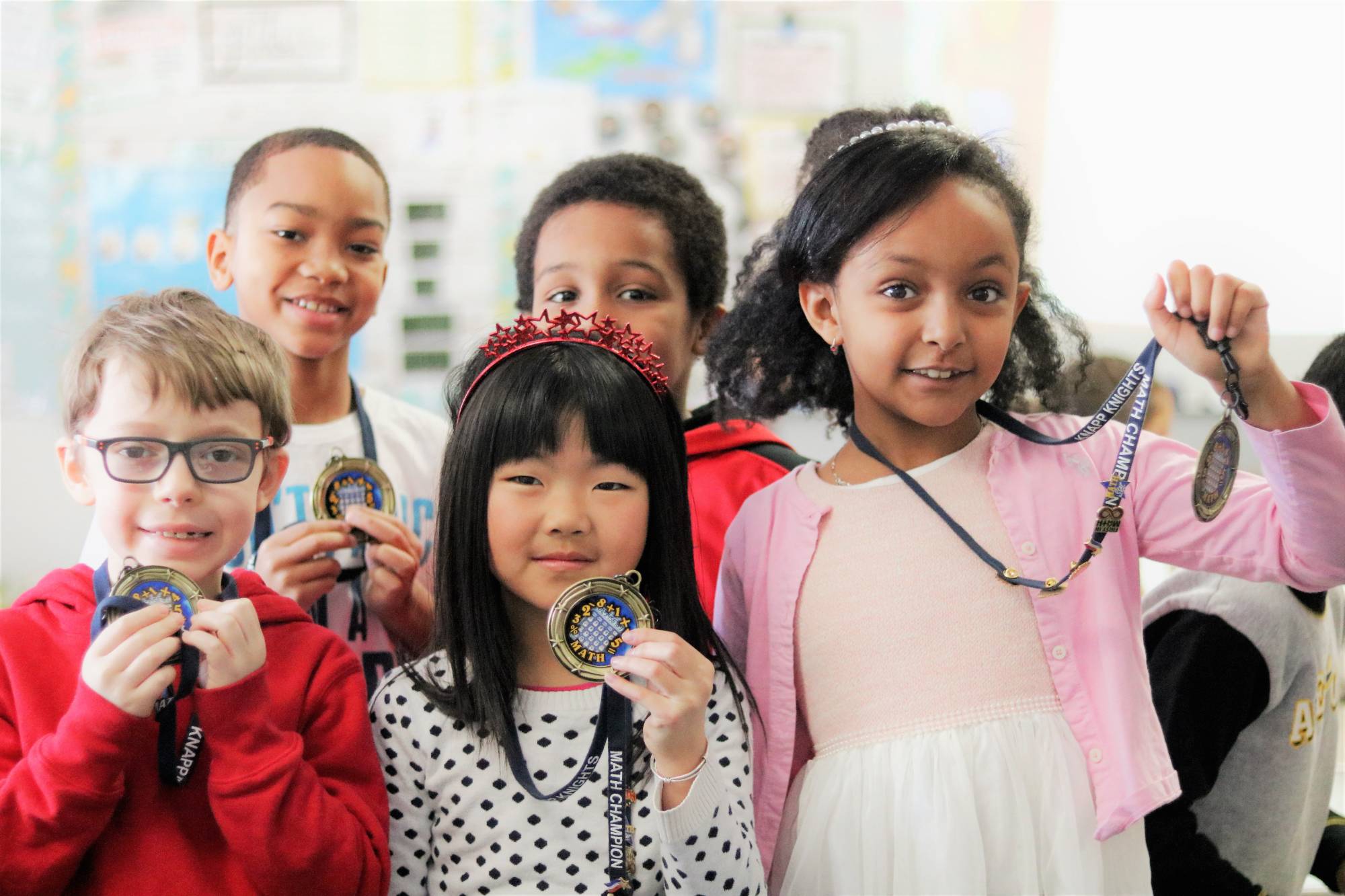 Group of students holding medals